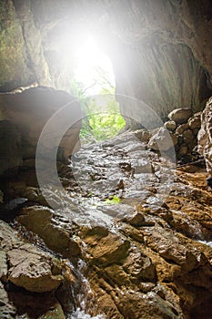 Stone cave inside view. Light exit