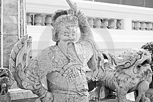 Stone Chinese Guardian at Wat Arun historic temple in Bangkok, Thailand