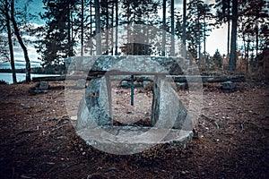 Stone Christian altar outdoors by a lake