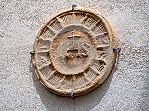 Stone Christogram on the walls of Bagnoreggio, Italy photo