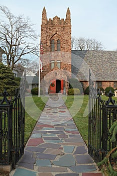 Stone church with open iron gate