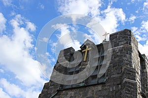 Stone church steeple against blue skies