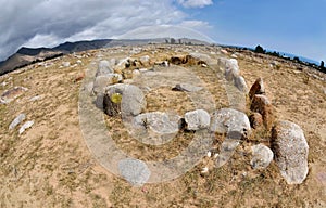 Stone circles in Cholpon Ata open air museum with ancient rock paintings, Issyk-Kul lake shore, Kyrgyzstan,Central Asia,unesco her