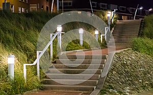 Stone city staircase going up with light lanterns urban cityscape scenery of the streets at night