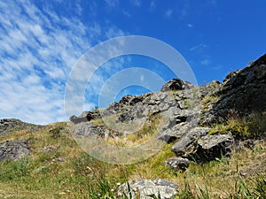 Stone cliffs rise against the blue sky