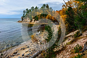 Stone coast in Pictured Rocks National Lakeshore, USA. Autumn forest on coast.