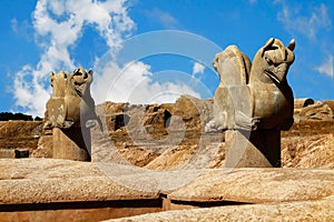 Stone column sculpture of a Griffin in Persepolis against a blue sky with clouds. The Victory symbol of the ancient Achaemenid Kin