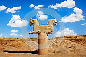 Stone column sculpture of a Griffin in Persepolis against a blue sky with clouds. The Victory symbol of the ancient Achaemenid Kin