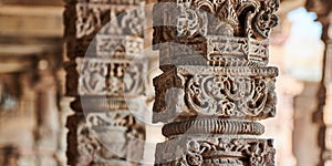 Stone columns with decorative bas relief of Qutb complex in South Delhi, India, close up pillars