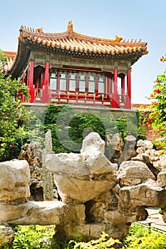 Stone composition bright red pavilion in the Imperial Garden of the Forbidden City. Beijing, China.