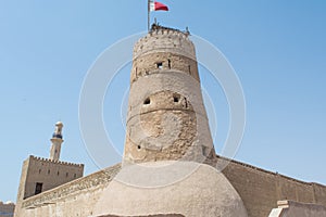 Stone cream colour ancient arabic fort with tower and high walls