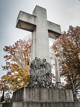 Stone cross in a cemetery in fall