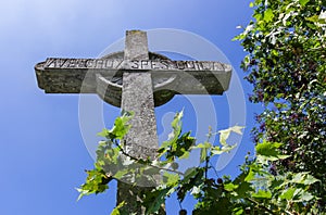 Stone cross on deep blue sky