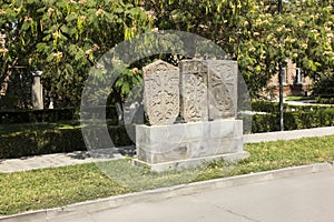 Stone cross in Echmiadzin Vagharshapat made of red stone tufa.