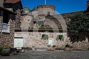 Stone cross and Flowers ,in the medieval town  of Malzieu , lozere France .a stage in the way of compostelle a long distance walk