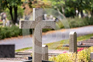 Stone cross on a graveyard in autumn..