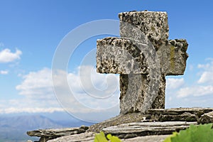 Stone cross at a mountain peak