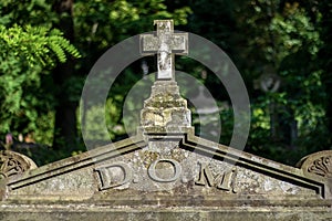 Stone cross on a tombstone. photo