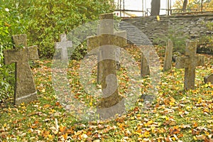 Stone crosses in the old cemetery in autumn