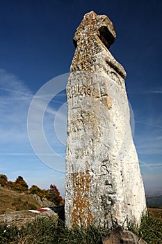 Stone crucifix profiled on blue sky