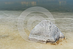 Stone with crystallized salt on Urmia Salt Lake. Iran photo