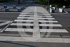 Stone cubes barriers as protection of a nice lawn cube cubes on a paved sidewalk platform of a tram protected from the entry of ca