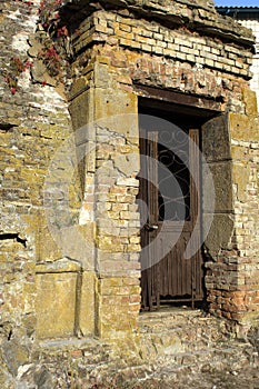 Stone curve Ruines wall with decorate iron door