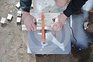 Stone cutter and arms of man.