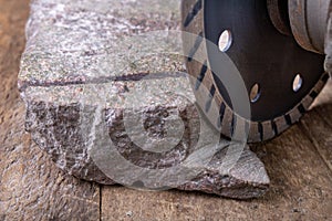 Stone cutting with a diamond disc mounted in a grinder. Work in a stone workshop