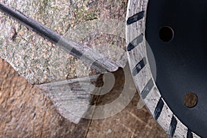 Stone cutting with a diamond disc mounted in a grinder. Work in a stone workshop