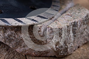 Stone cutting with a diamond disc mounted in a grinder. Work in a stone workshop