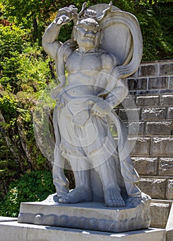 Stone demon guard statuesque, guardian statue at the entrance to the Korean Buddhist Temple Guinsa. Danyang Region, South Korea,