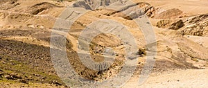 Stone desert in Jordan, hostile landscape next to the Kings Highway in front of Wadi Mujib, deeply cut into the landscape