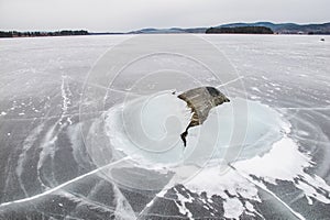 A stone is dramatically breaking the ice, literally photo