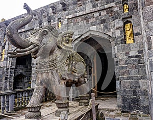 Stone elephant sculpture with his trunk up