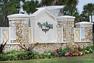 Stone entrance sign to The Villages in Florida in spring.