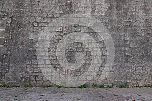 Stone facade grey street wall assembled with gray pebbles of different sizes background