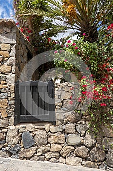 Stone facade of a house decorated with flowers