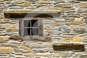 Stone facade with wooden window frame, front view