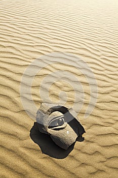 Stone face on desert