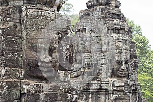 Stone face smile of ancient buddhist temple Bayon in Angkor Wat complex, Cambodia. Khmer art.