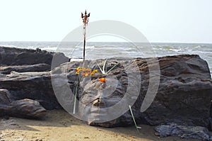 Stone face on tropical beach in Goa