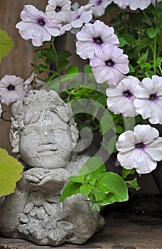 Stone fairie and petunias