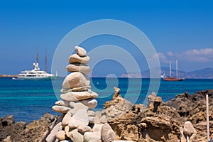 Stone figures on beach shore of Illetes beach in Formentera photo