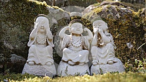 Stone figures of buddha acting like three wise monkeys Mizaru, Kikazaru, Iwazaru