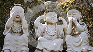 Stone figures of buddha acting like three wise monkeys Mizaru, Kikazaru, Iwazaru