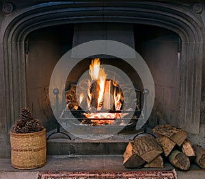 Stone fireplace with a lit roaring fire