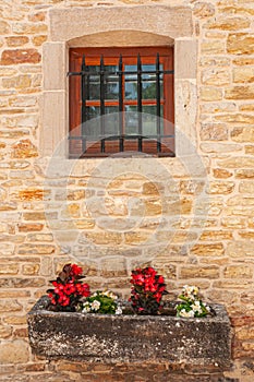 Stone flower planter and barred window