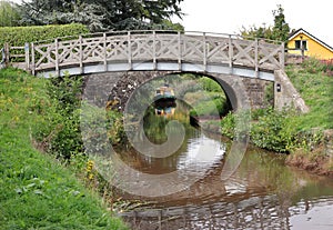 Stone foot Bridge over the Brecon and Monmouthshire canal in South Wales with narrowboat