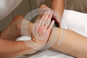 Stone foot massage. Patient receiving foot massage.